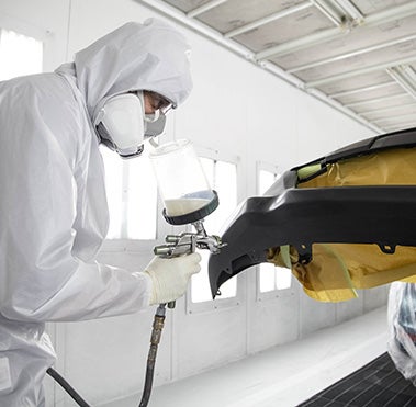 Collision Center Technician Painting a Vehicle | Toyota of York in York PA