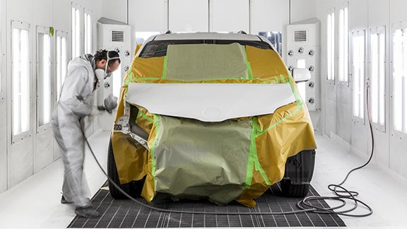 Collision Center Technician Painting a Vehicle | Toyota of York in York PA